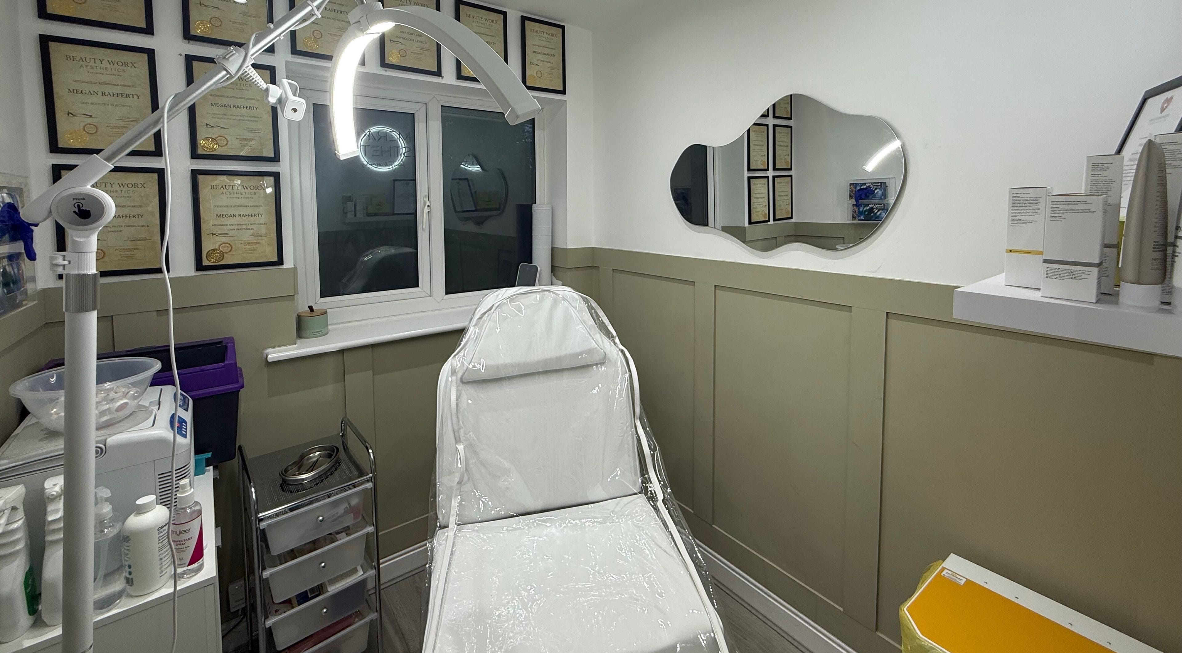 Well-equipped treatment room at Meraki Aesthetics, Eccles, England, GB showcasing beauty certificates and modern design.