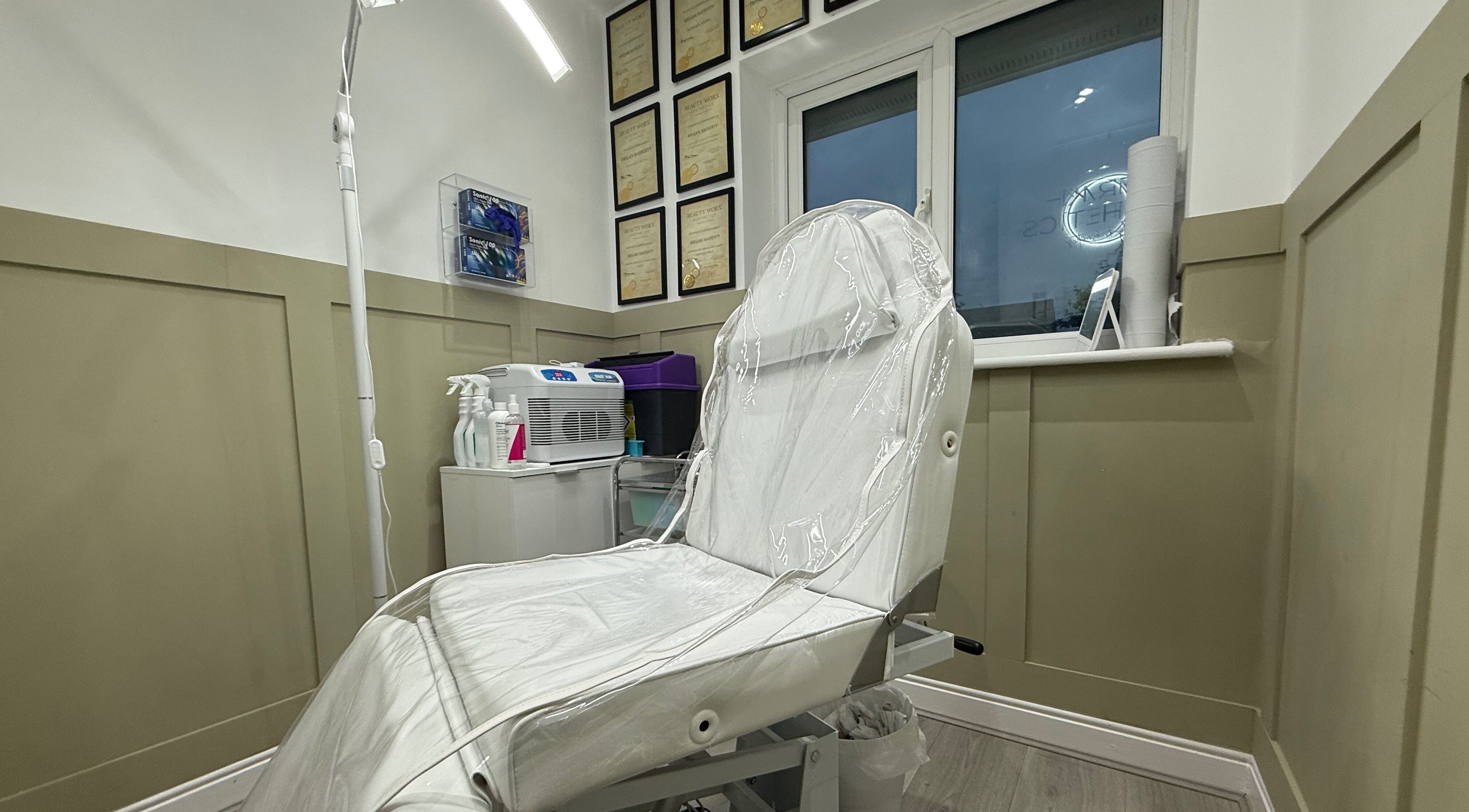 Modern aesthetic clinic room at Meraki Aesthetics in Eccles, England, GB, showcasing a pristine treatment chair.