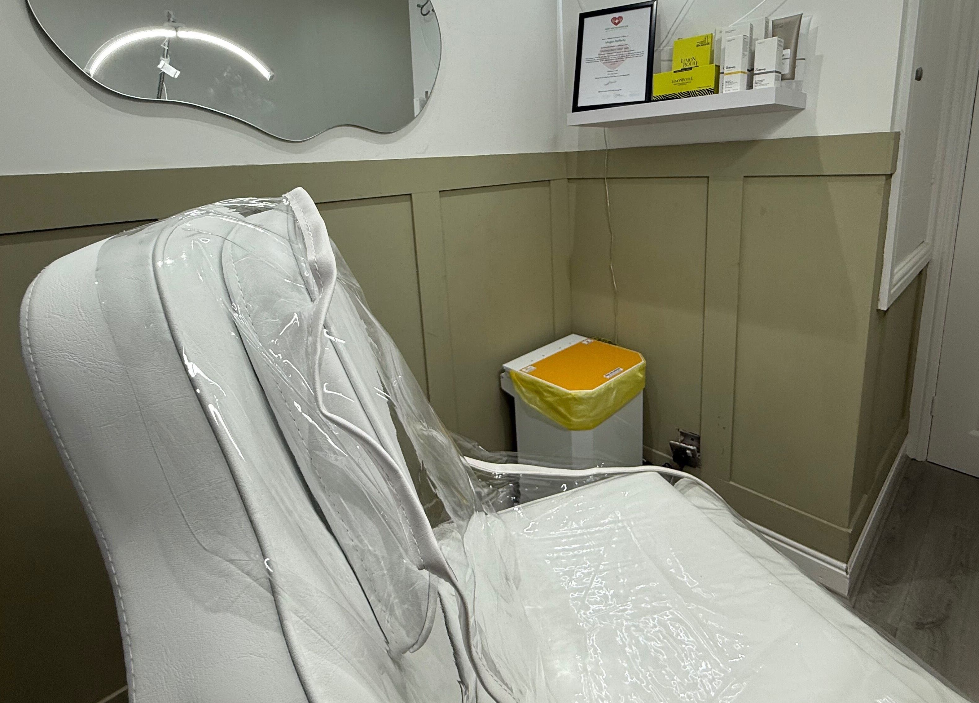 A cozy treatment room with a white chair at Meraki Aesthetics, Eccles, England, GB.