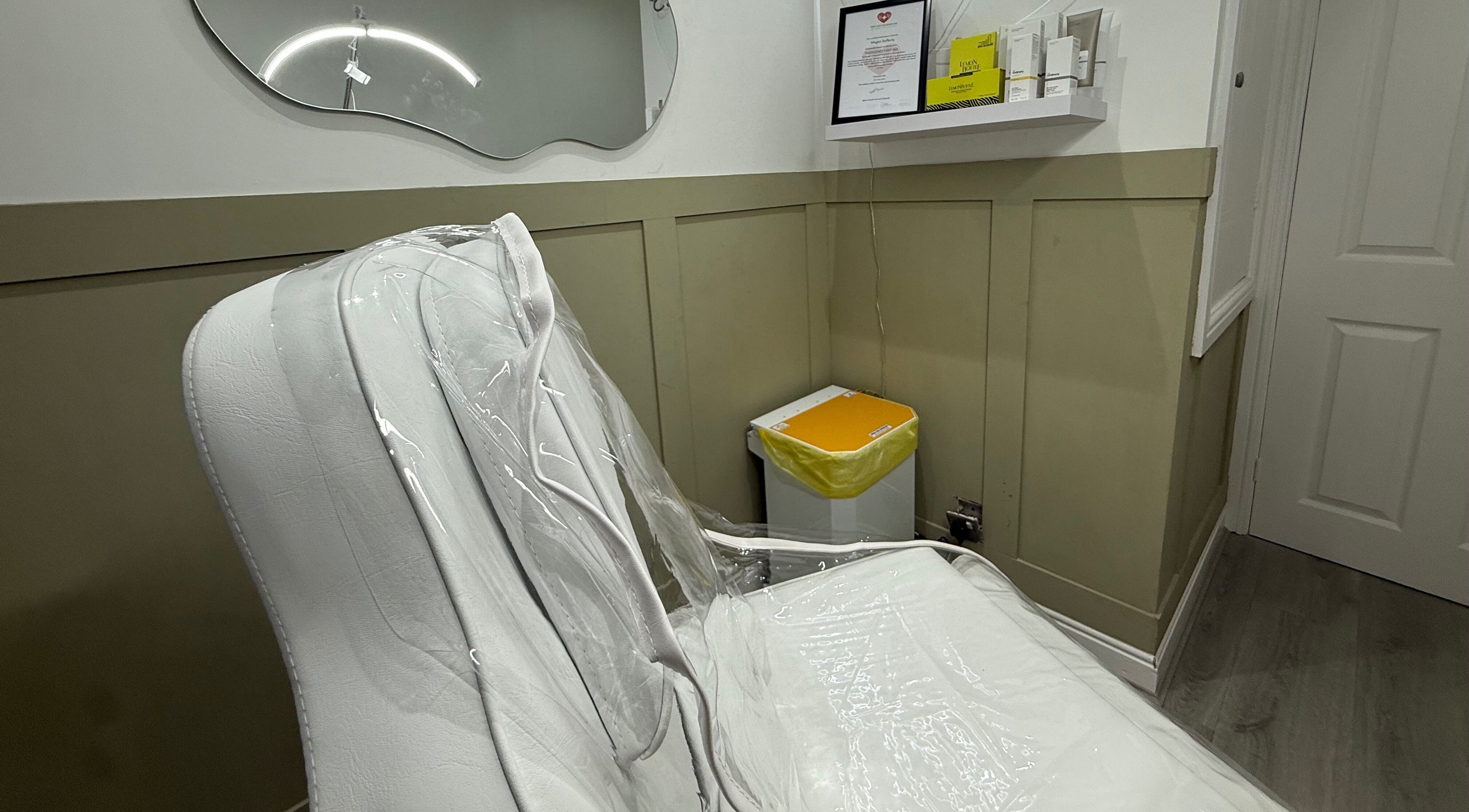 A cozy treatment room with a white chair at Meraki Aesthetics, Eccles, England, GB.