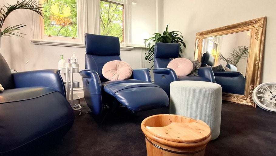 Cozy lounge area at Little Pigeon Massage and Waxing, Melbourne, Victoria, AU featuring blue chairs and plants.