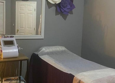 Tranquil massage room at Purple Rain Lymphatic Massage, Tampa, Florida, US featuring massage bed and equipment.
