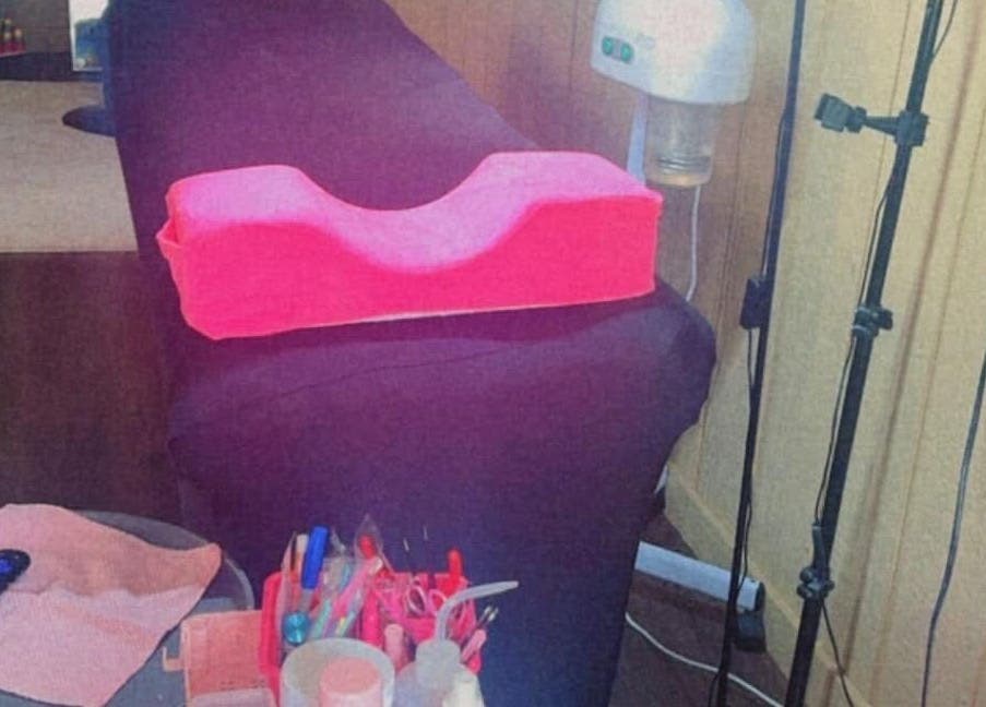 Lash treatment bed at Better u lash, Moore, Oklahoma, US with pink headrest and beauty tools.