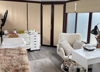 Relaxing treatment room at Neta Skin and Beauty Clinic, Buxton, England, GB, with plush bed and cozy decor.