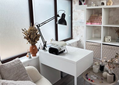 A cozy nail station at Neta Skin and Beauty Clinic, Buxton, England, GB with a white desk and modern decor.