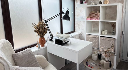 A cozy nail station at Neta Skin and Beauty Clinic, Buxton, England, GB with a white desk and modern decor.