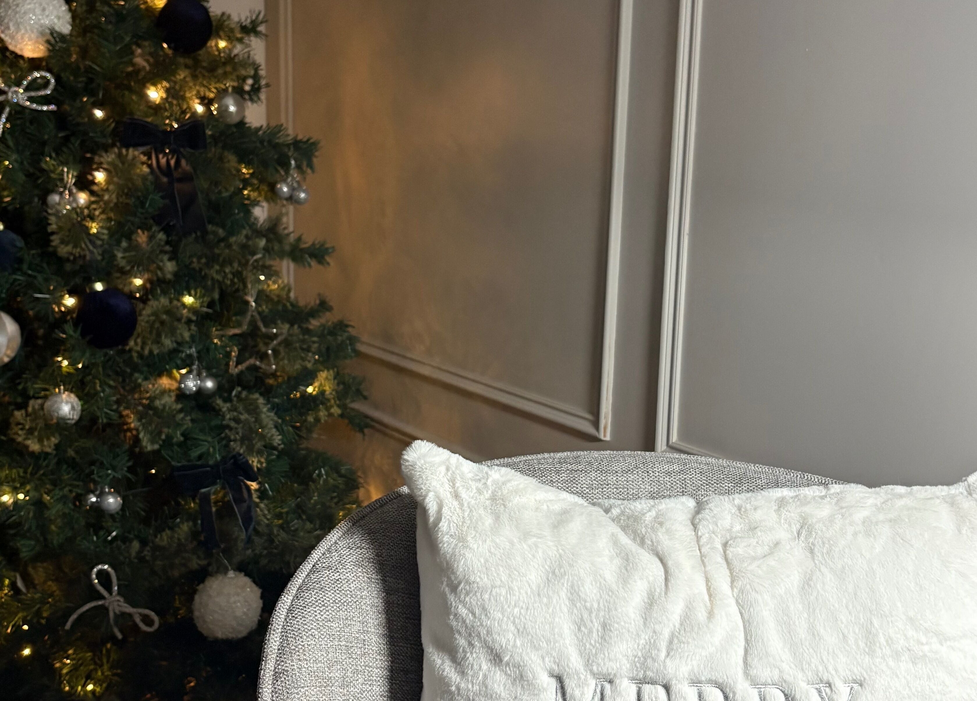 Festive Christmas decor at The Gloss Lab - nails by Claudia, featuring a lit tree and plush seating in Cannock, England, GB.