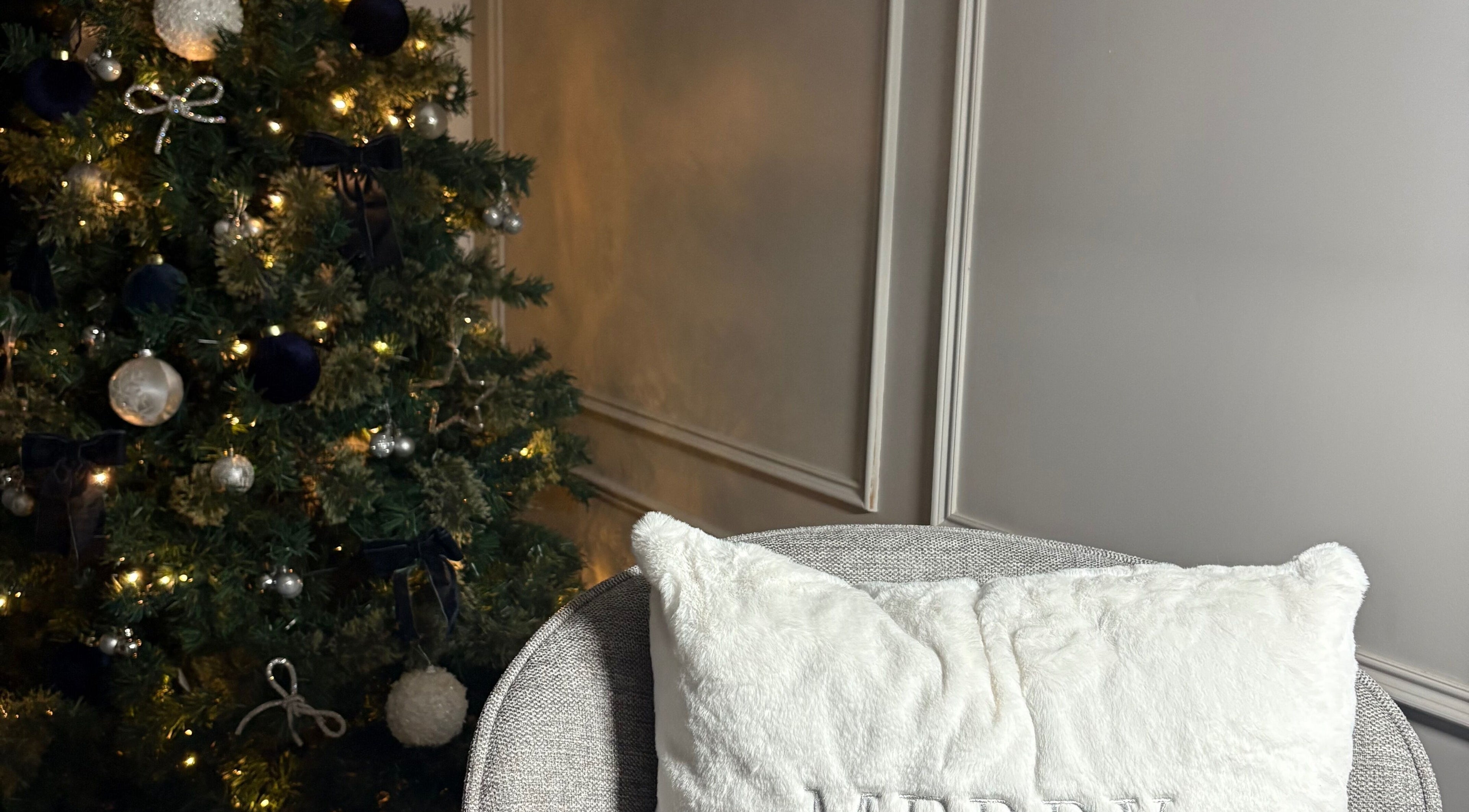 Festive Christmas decor at The Gloss Lab - nails by Claudia, featuring a lit tree and plush seating in Cannock, England, GB.