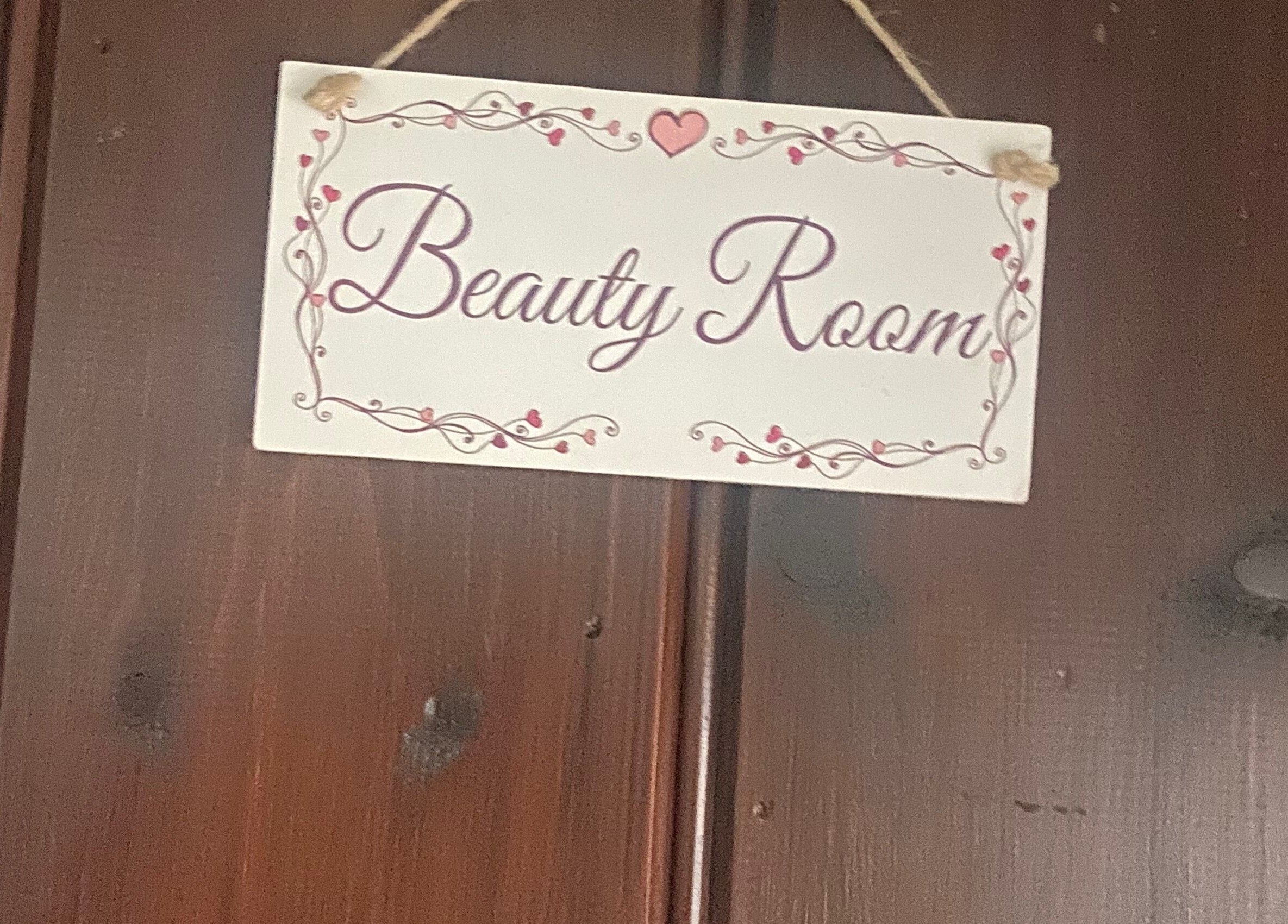 Charming Beauty Room sign at Ellas Luxe Nails, Kirk Michael, IM, welcoming clients with elegance.