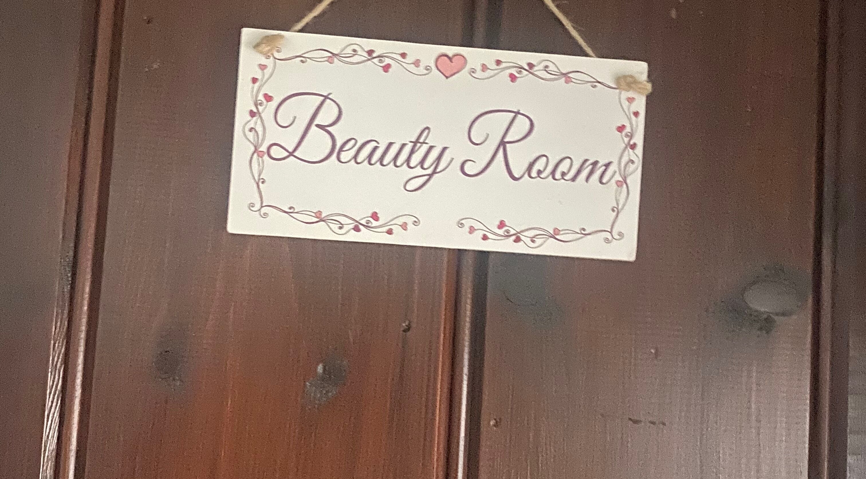 Charming Beauty Room sign at Ellas Luxe Nails, Kirk Michael, IM, welcoming clients with elegance.