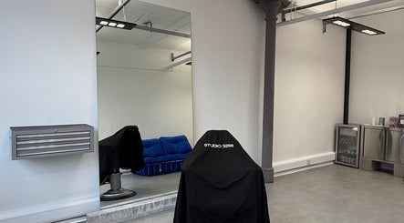 Minimalist interior of STUDIO 3266 in Manchester, England, GB, featuring a modern salon chair and sleek decor.