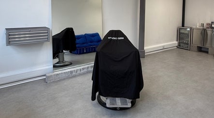 Stylish chair draped with cover in STUDIO 3266, Manchester, England, GB. Modern and sleek interior.