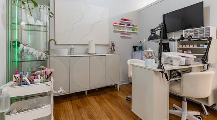 Nail station at Sophisticuts Beauty Salon, Katy, Texas, US showcasing tools and colorful nail polishes.