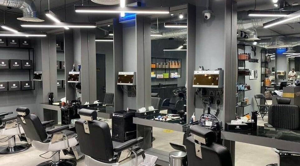 Sleek interior of Al Rayan | 30 Degrees Barbershop, Riyadh, with modern barber chairs and elegant mirrors.