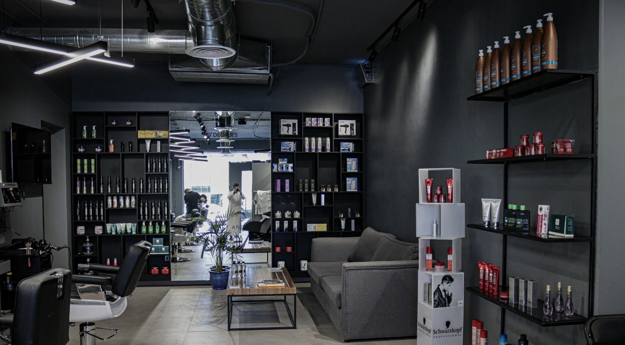 Interior of Al Rayan | 30 Degrees Barbershop, Riyadh. Chic design with product displays and styling chairs.