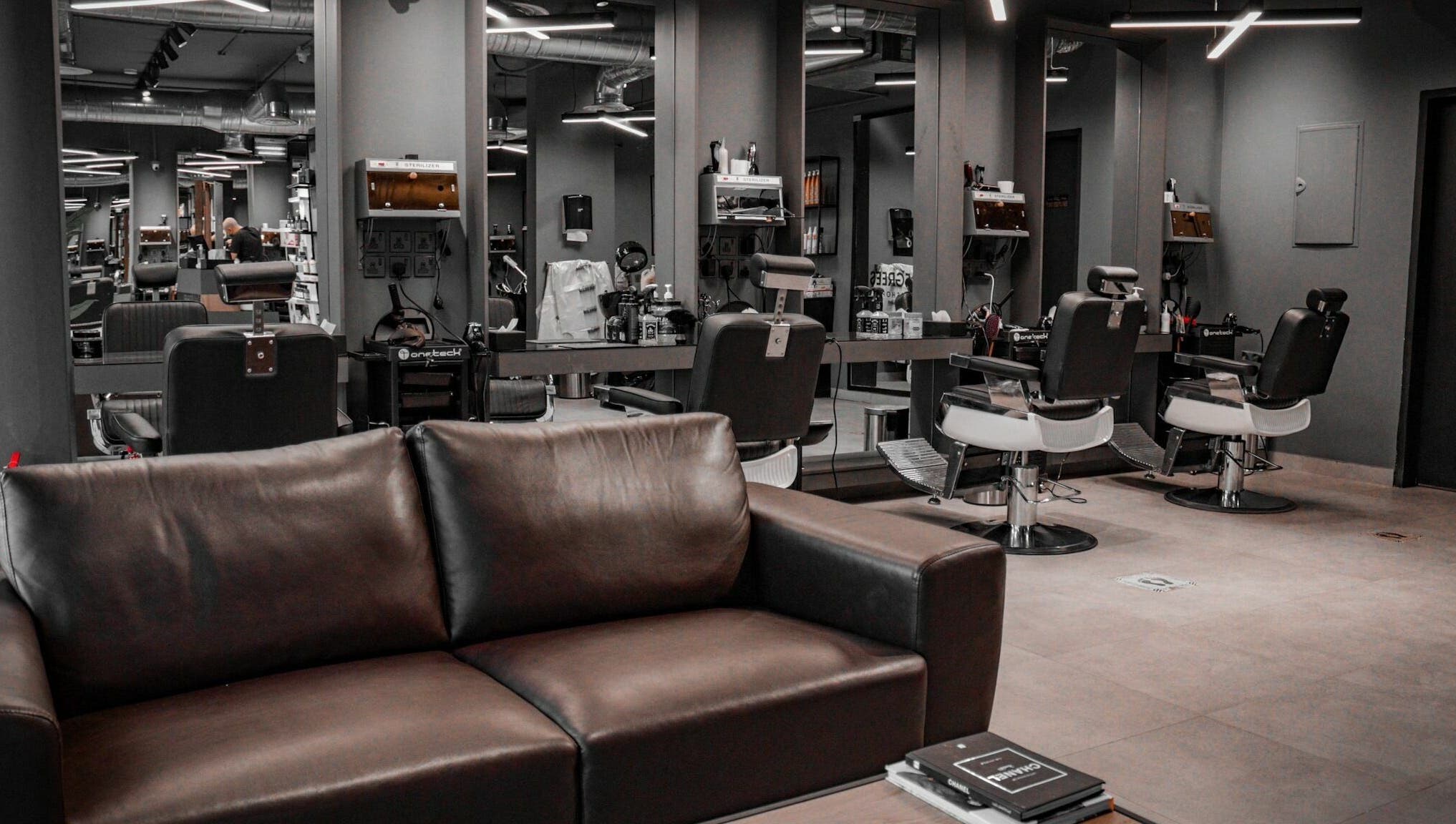 Sleek interior of Al Izdihar 30 Degrees Barbershop in Riyadh, Riyadh Province, SA with stylish chairs and mirrors.