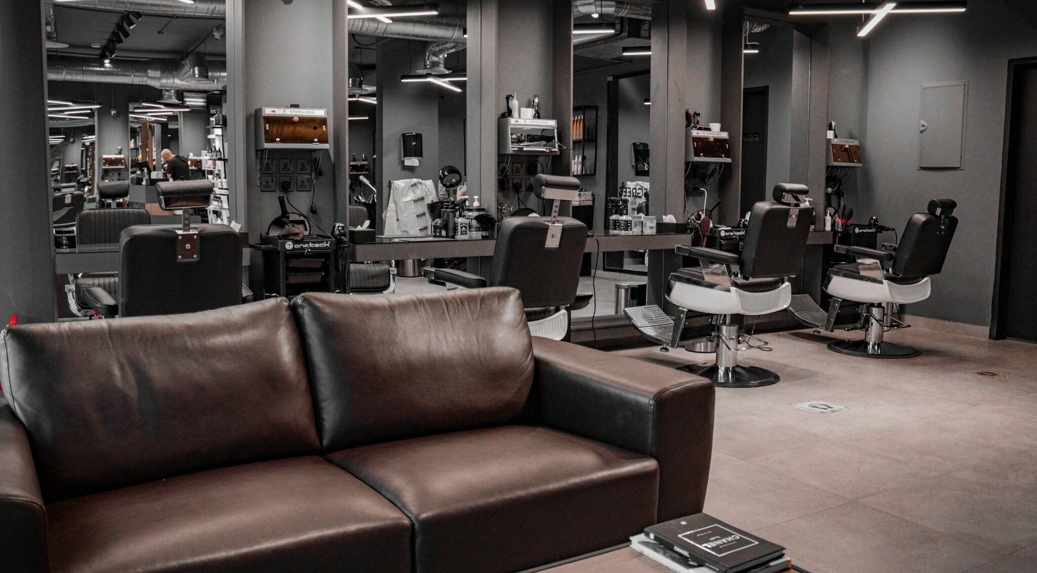 Sleek interior of Al Izdihar 30 Degrees Barbershop in Riyadh, Riyadh Province, SA with stylish chairs and mirrors.