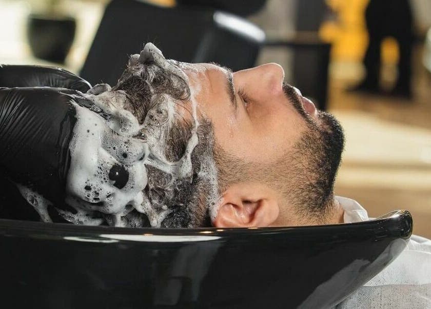 Client enjoying hair wash at Al Izdihar 30 Degrees Barbershop in Riyadh, Riyadh Province, SA.