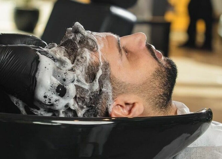 Client enjoying hair wash at Al Izdihar 30 Degrees Barbershop in Riyadh, Riyadh Province, SA.