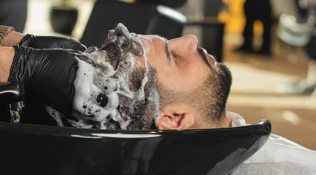 Client enjoying hair wash at Al Izdihar 30 Degrees Barbershop in Riyadh, Riyadh Province, SA.