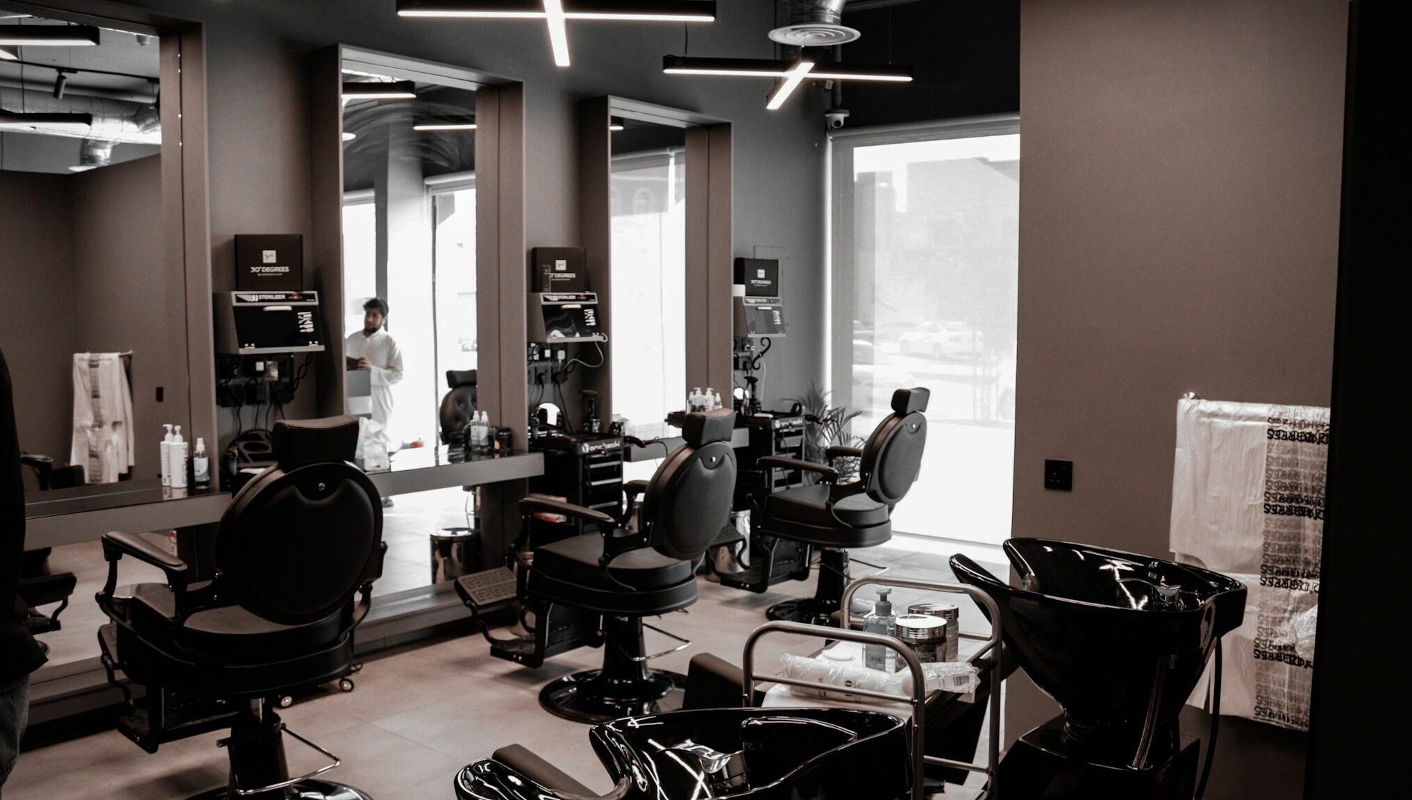 Chic interior of AlNarjis 30 Degrees Barbershop in Riyadh, Riyadh Province, SA showcasing stylish chairs and mirrors.