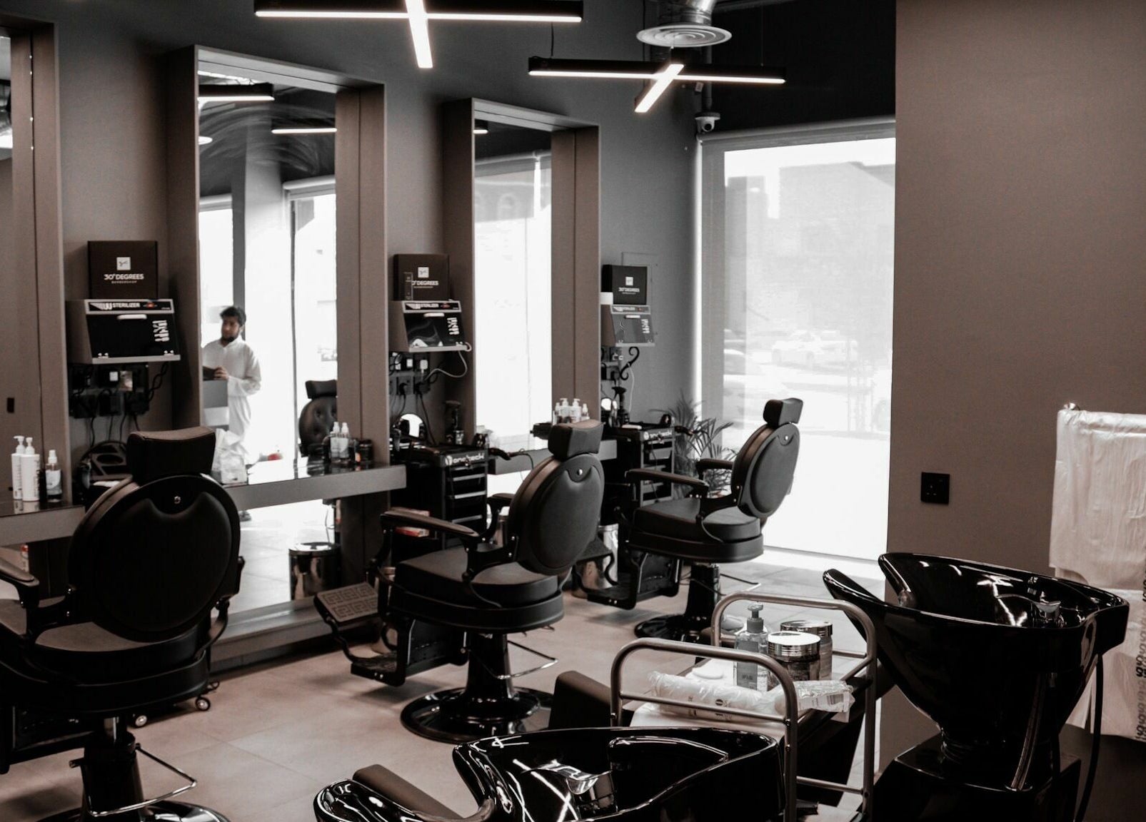 Chic interior of AlNarjis 30 Degrees Barbershop in Riyadh, Riyadh Province, SA showcasing stylish chairs and mirrors.