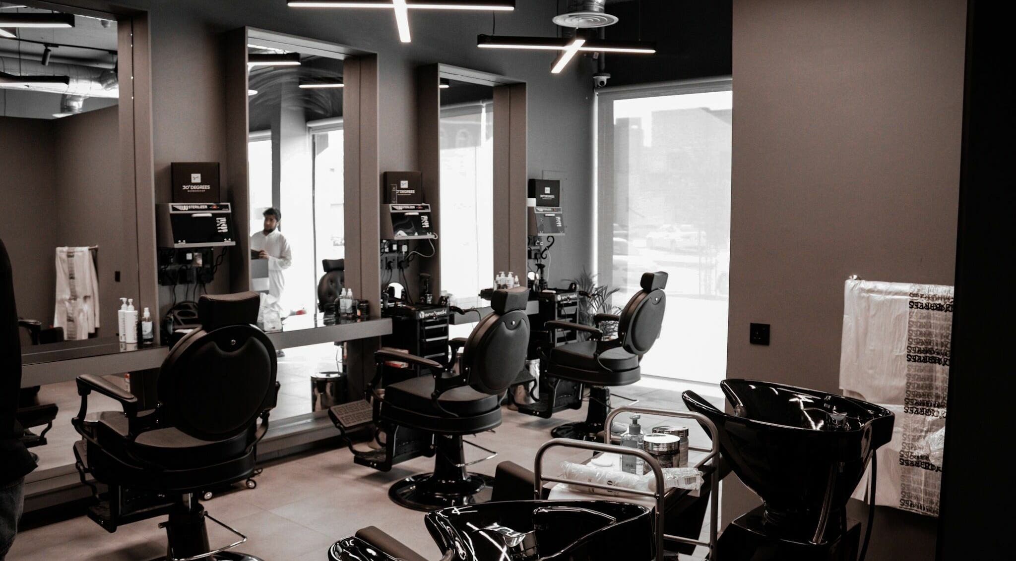 Chic interior of AlNarjis 30 Degrees Barbershop in Riyadh, Riyadh Province, SA showcasing stylish chairs and mirrors.