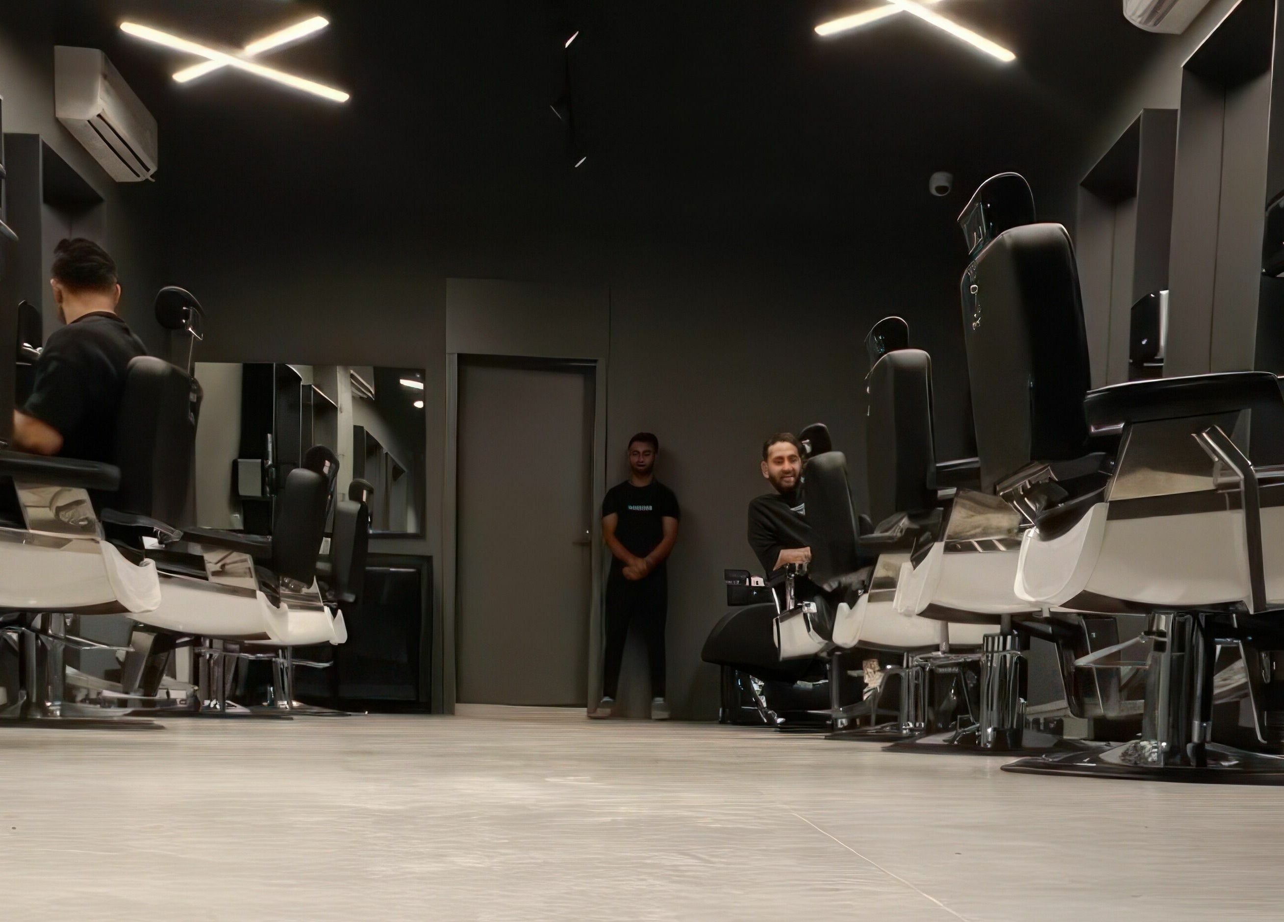 Stylish interior of AlNarjis 30 Degrees Barbershop in Riyadh, Riyadh Province, SA, showcasing sleek barber chairs.