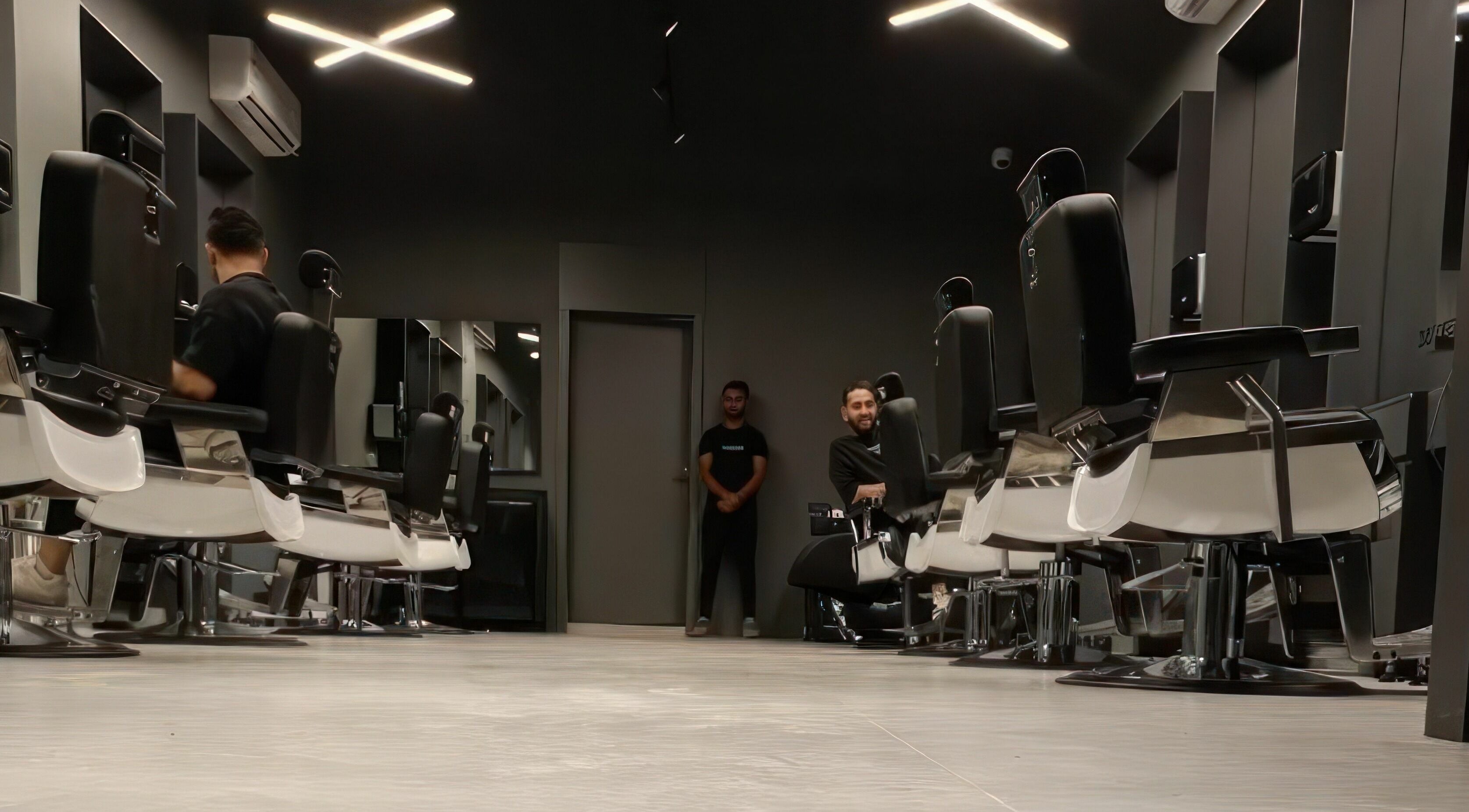 Stylish interior of AlNarjis 30 Degrees Barbershop in Riyadh, Riyadh Province, SA, showcasing sleek barber chairs.