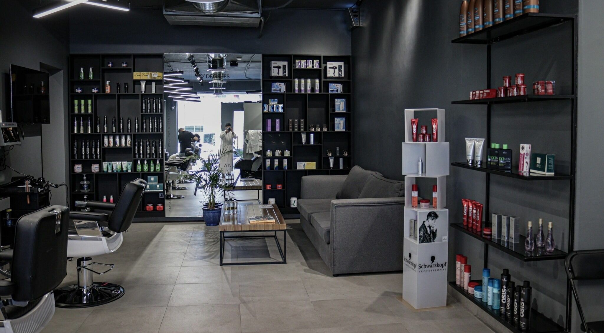 Modern interior of Al Hamra | 30 Degrees Barbershop, Riyadh, Riyadh Province, SA, featuring sleek seating and products.