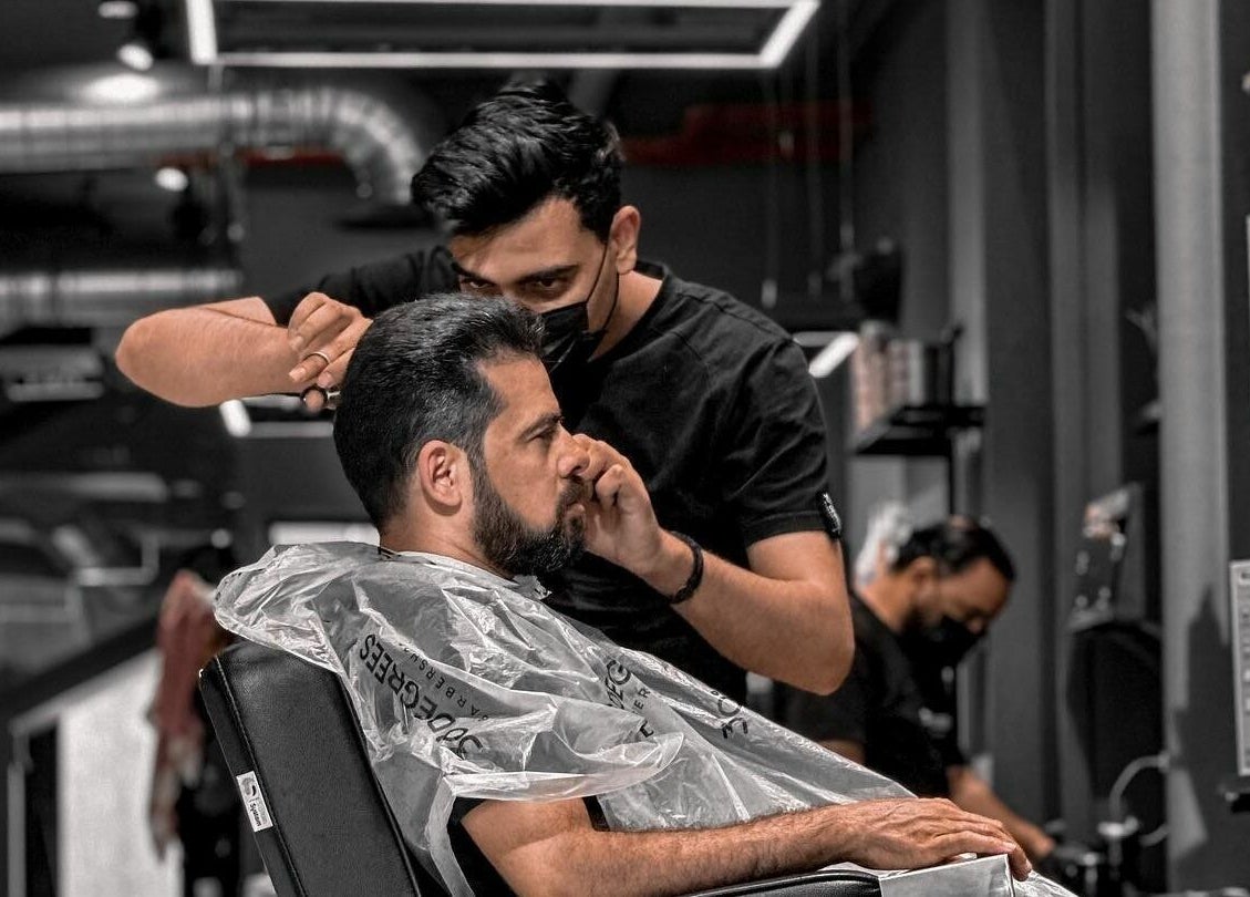 Expert barber at Al Khobar 30 Degrees Barbershop | Olaya Branch, Al Khobar, Eastern Province, SA, styling a client.
