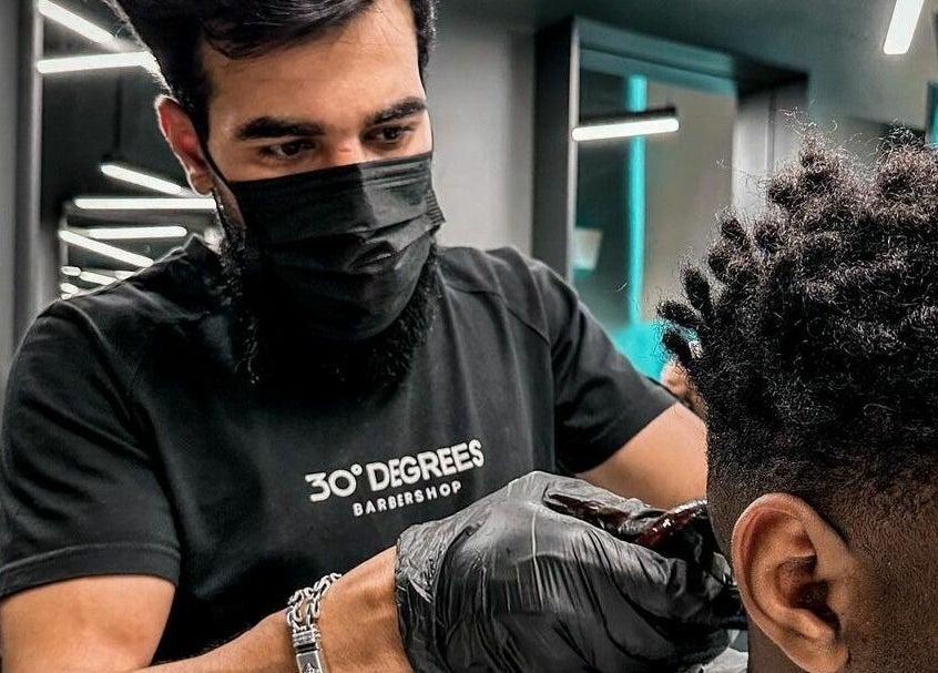 Barber stylizing hair at Al Khobar 30 Degrees Barbershop | Olaya Branch, Al Khobar, Eastern Province, SA.
