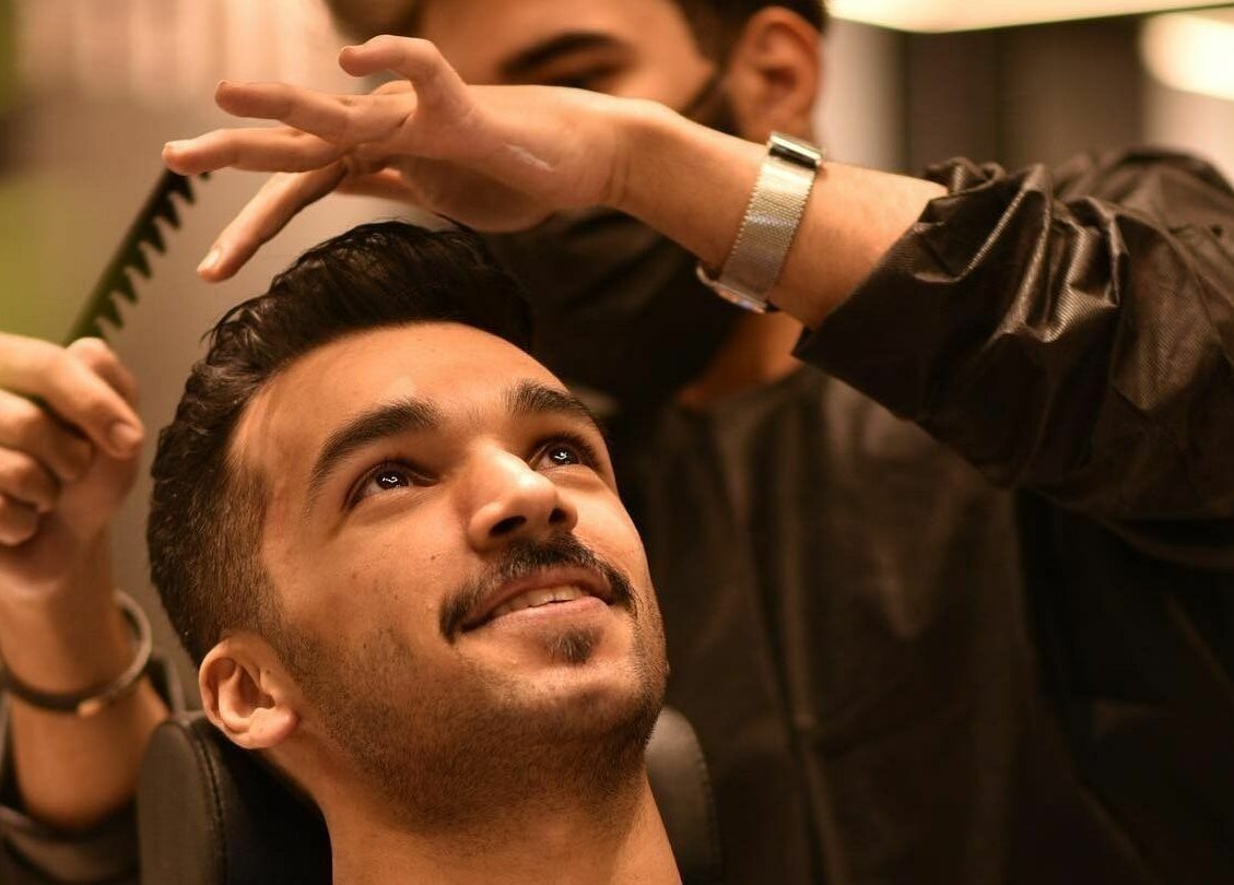 Stylist trims hair at Al Khobar 30 Degrees Barbershop | Olaya Branch, Al Khobar, Eastern Province, SA.