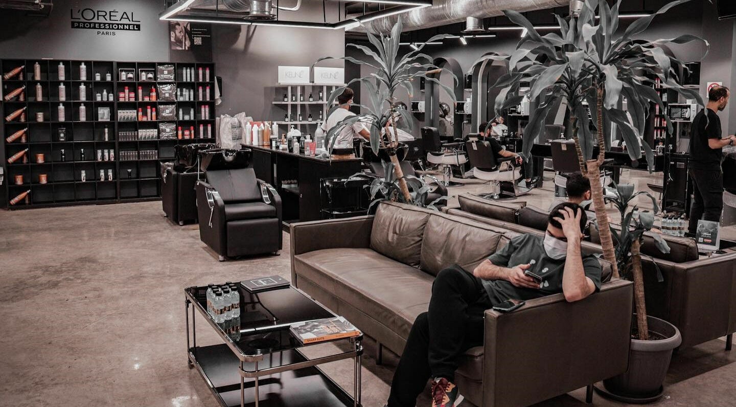 Interior of Al Mohamadyah 30 Degrees Barbershop in Riyadh showcasing stylish décor and seating area.