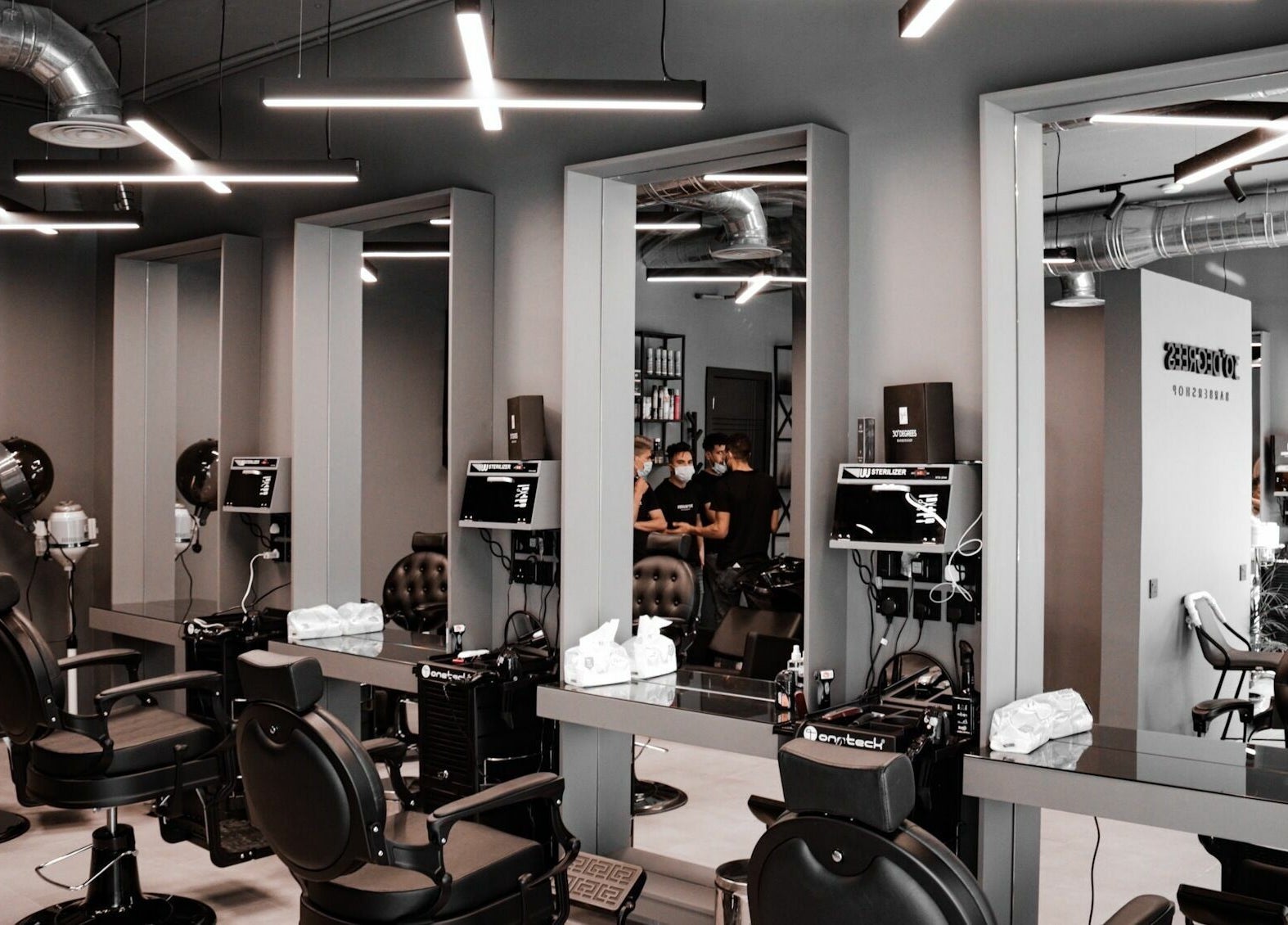 Modern interior of AlUla 30 Degrees Barbershop in AlUla, Eastern Province, SA, featuring sleek barber chairs.