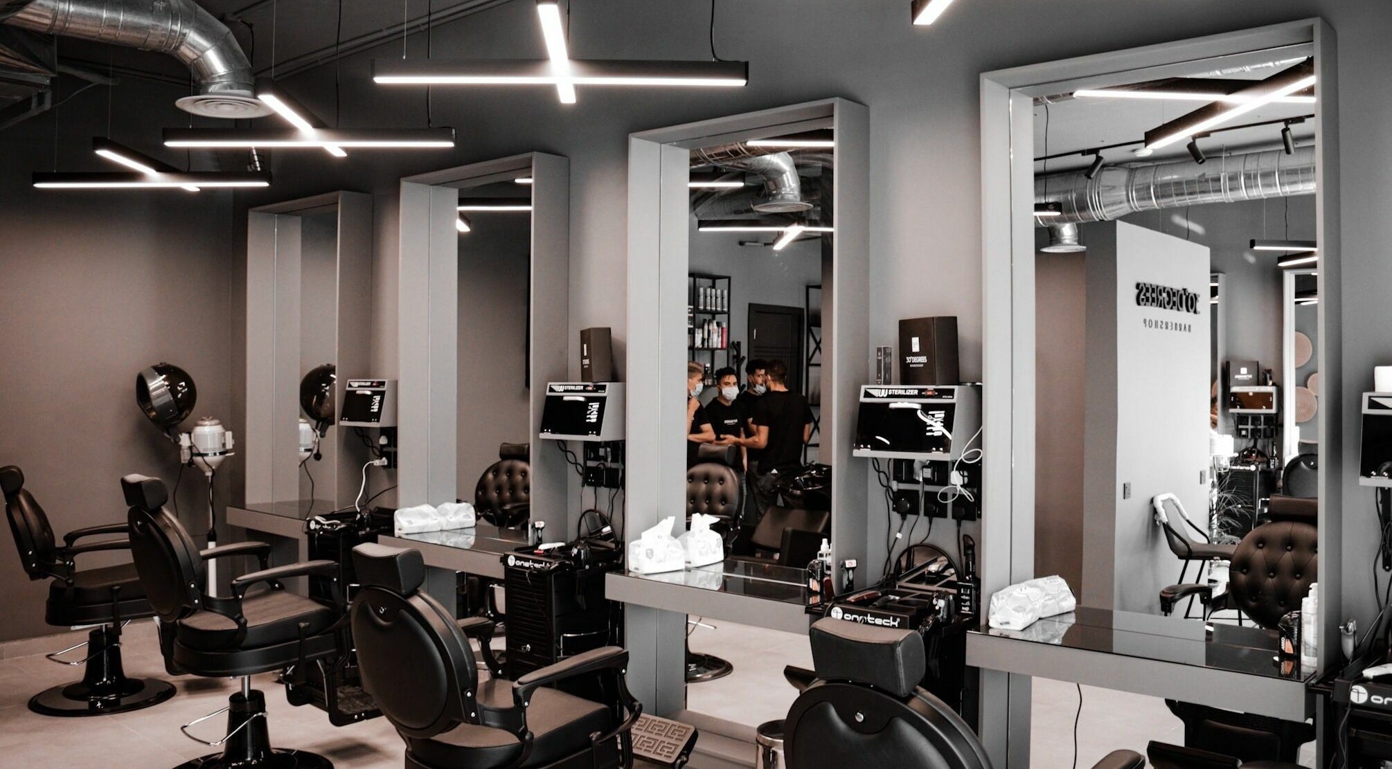 Modern interior of AlUla 30 Degrees Barbershop in AlUla, Eastern Province, SA, featuring sleek barber chairs.