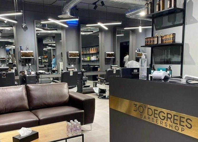 Modern interior of AlUla 30 Degrees Barbershop, elegant seating, mirrors, and grooming stations in AlUla, Eastern Province, SA.