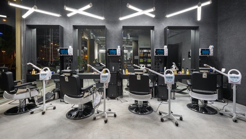 Modern interior of Al Nakheel 30 Degrees Barbershop in Riyadh, Riyadh Province, SA with sleek styling chairs.