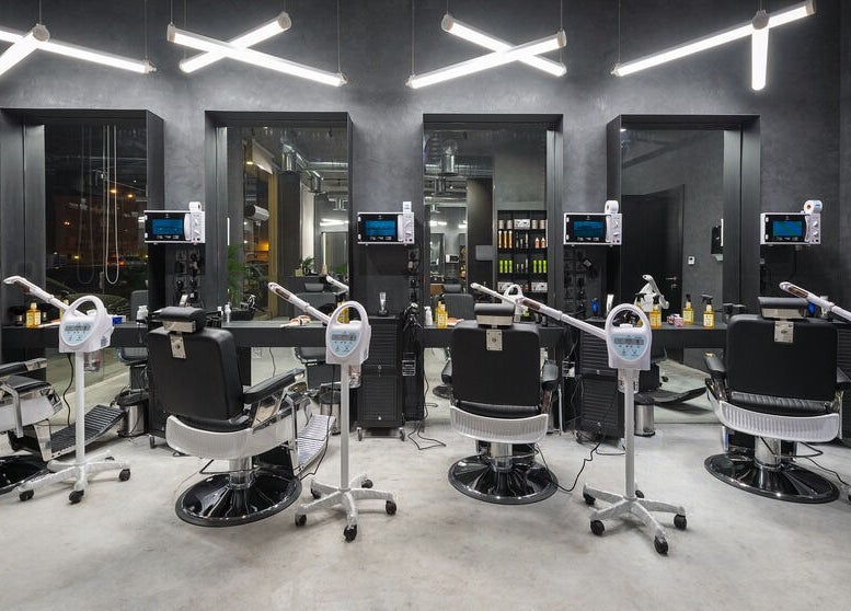 Modern interior of Al Nakheel 30 Degrees Barbershop in Riyadh, Riyadh Province, SA with sleek styling chairs.
