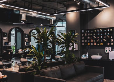 Modern interior of 30 Degrees Barbershop, Makkah with stylish decor and grooming products on display.