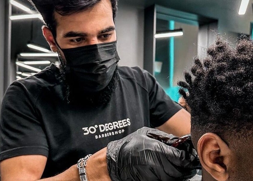 Professional barber styling hair at Dhahran 30 Degrees Barbershop | AlQusur Branch, Dhahran, Eastern Province, SA.