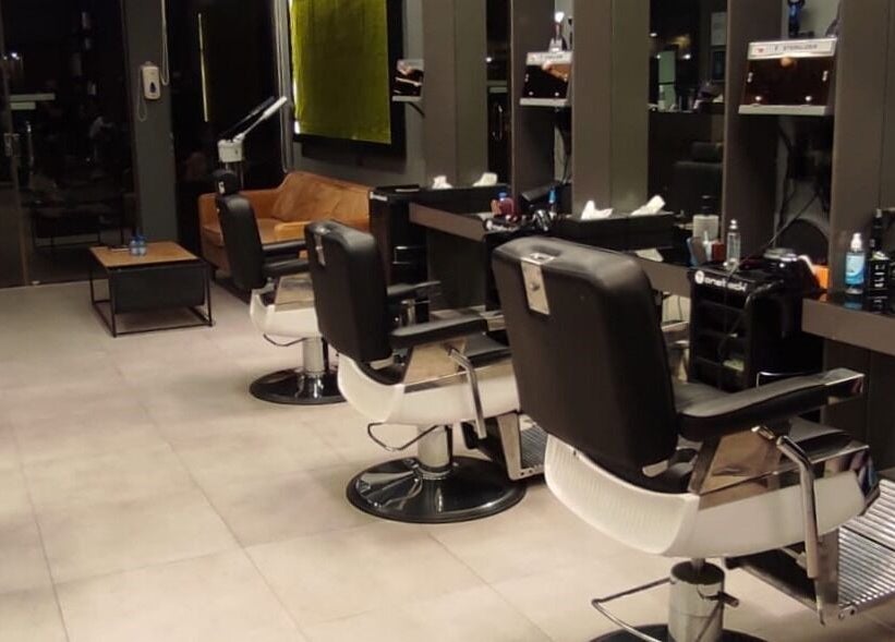 Modern salon interior at Hittin 30 Degrees, Riyadh, Riyadh Province, SA with sleek chairs and styling stations.