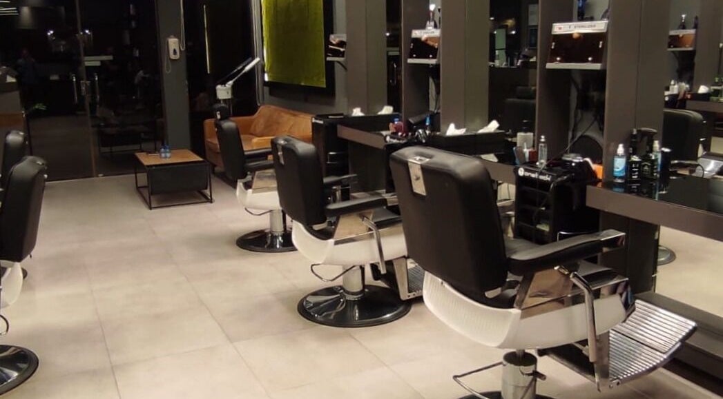 Modern salon interior at Hittin 30 Degrees, Riyadh, Riyadh Province, SA with sleek chairs and styling stations.