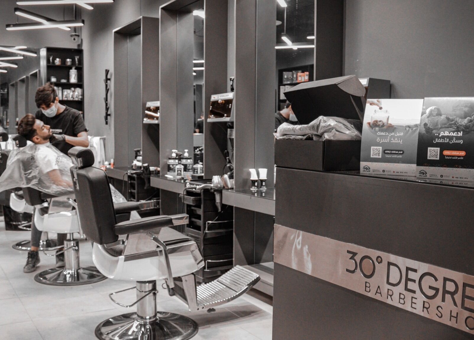 Modern barber shop interior at Hittin 30 Degrees, Riyadh, Riyadh Province, SA, featuring stylish chairs and decor.