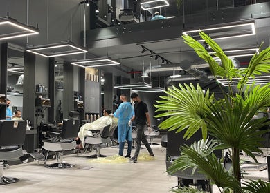 Modern barber chairs lined up at Al Malqa 30 Degrees, Riyadh Province, offering stylish haircuts and grooming services.