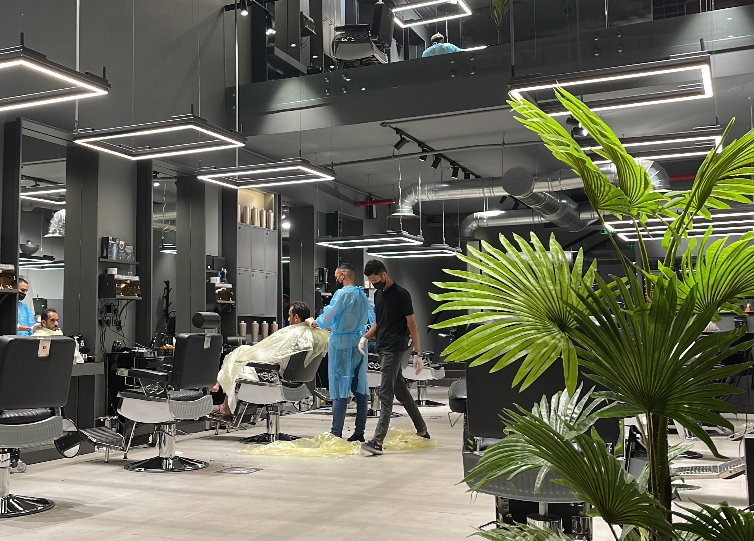 Modern barber chairs lined up at Al Malqa 30 Degrees, Riyadh Province, offering stylish haircuts and grooming services.
