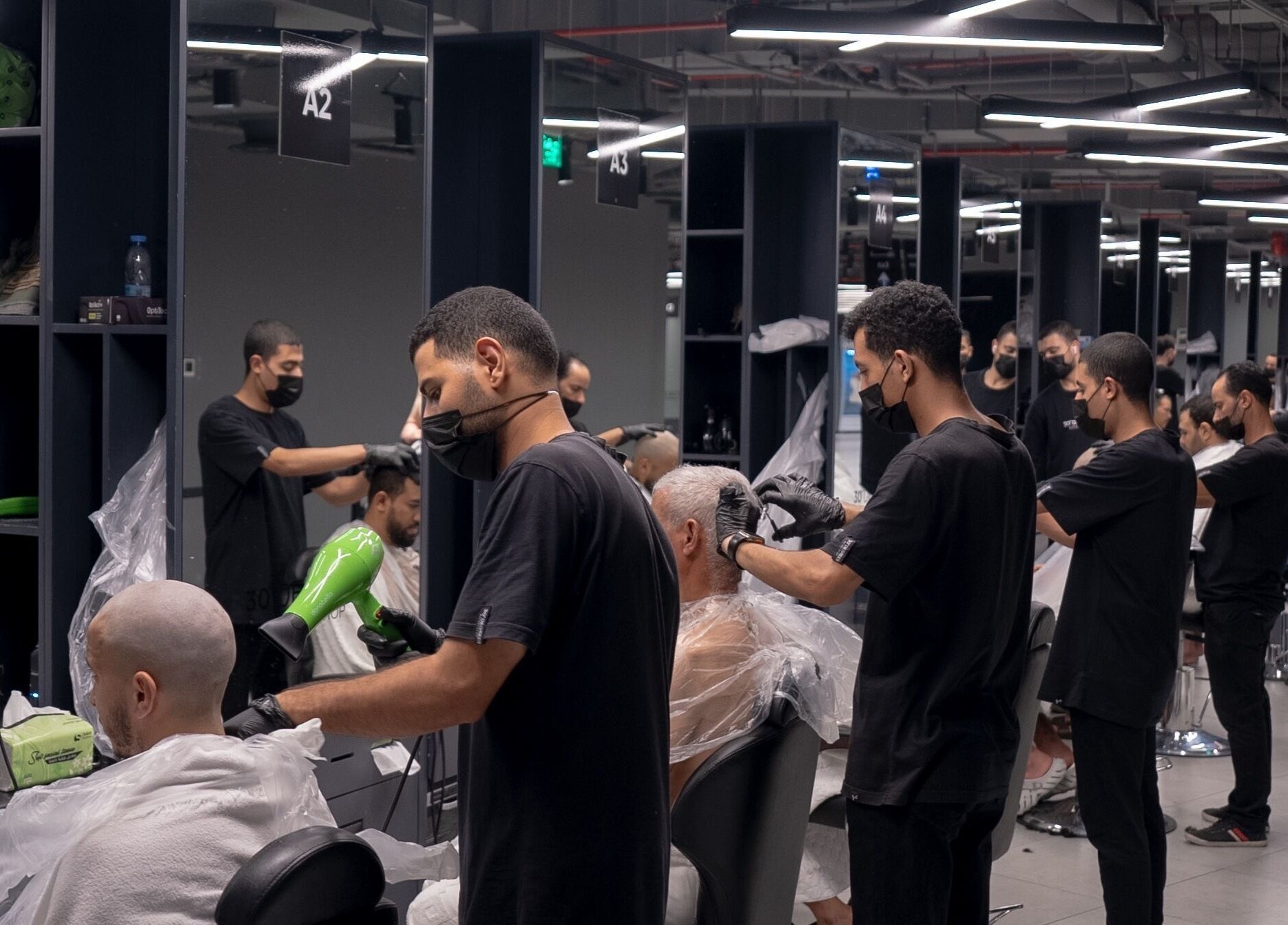Barbers working in 30 Degrees Clock Tower, Makkah, Makkah Province, SA, providing stylish haircuts.