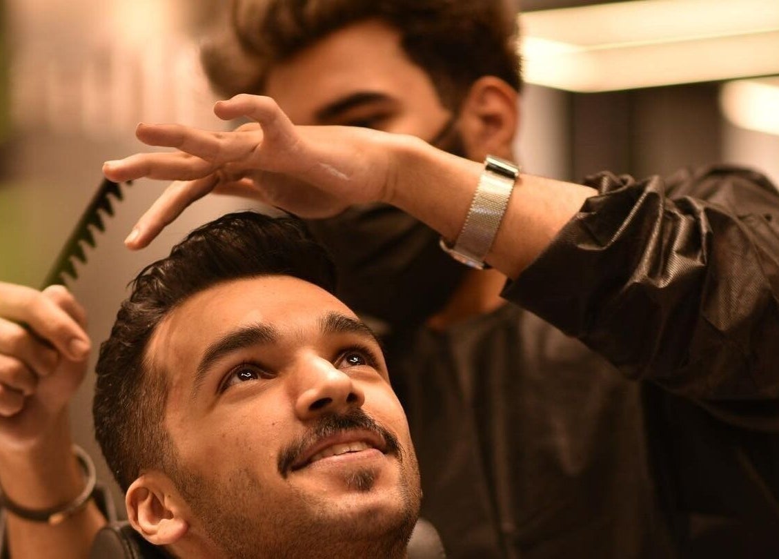 Hair stylist in Al Aarid | 30 Degrees crafting a client's look in Riyadh, Riyadh Province, SA.