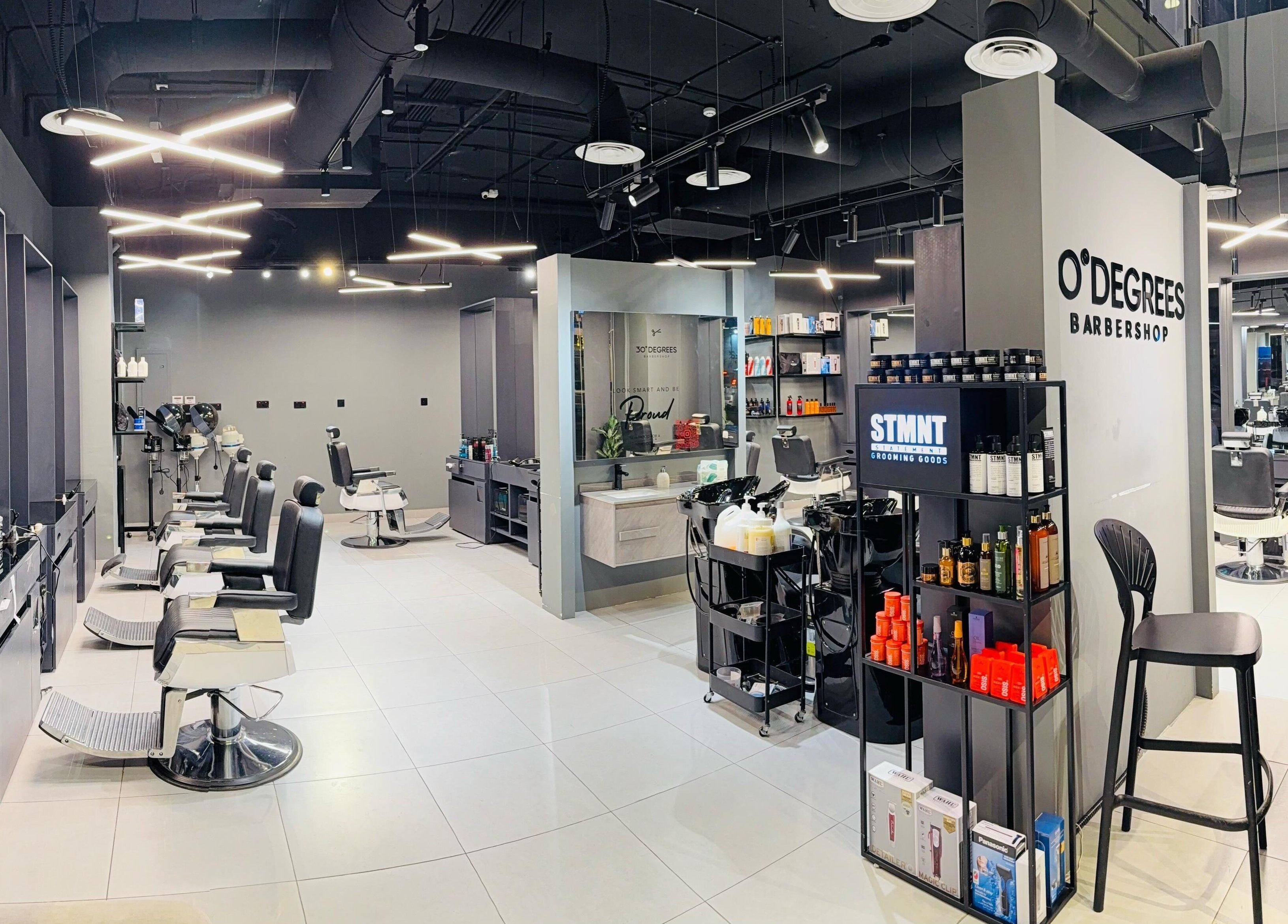 Interior of Jeddah 30 Degrees Alnaeem barbershop in Jeddah, Makkah Province, SA. Sleek chairs and stylish decor.