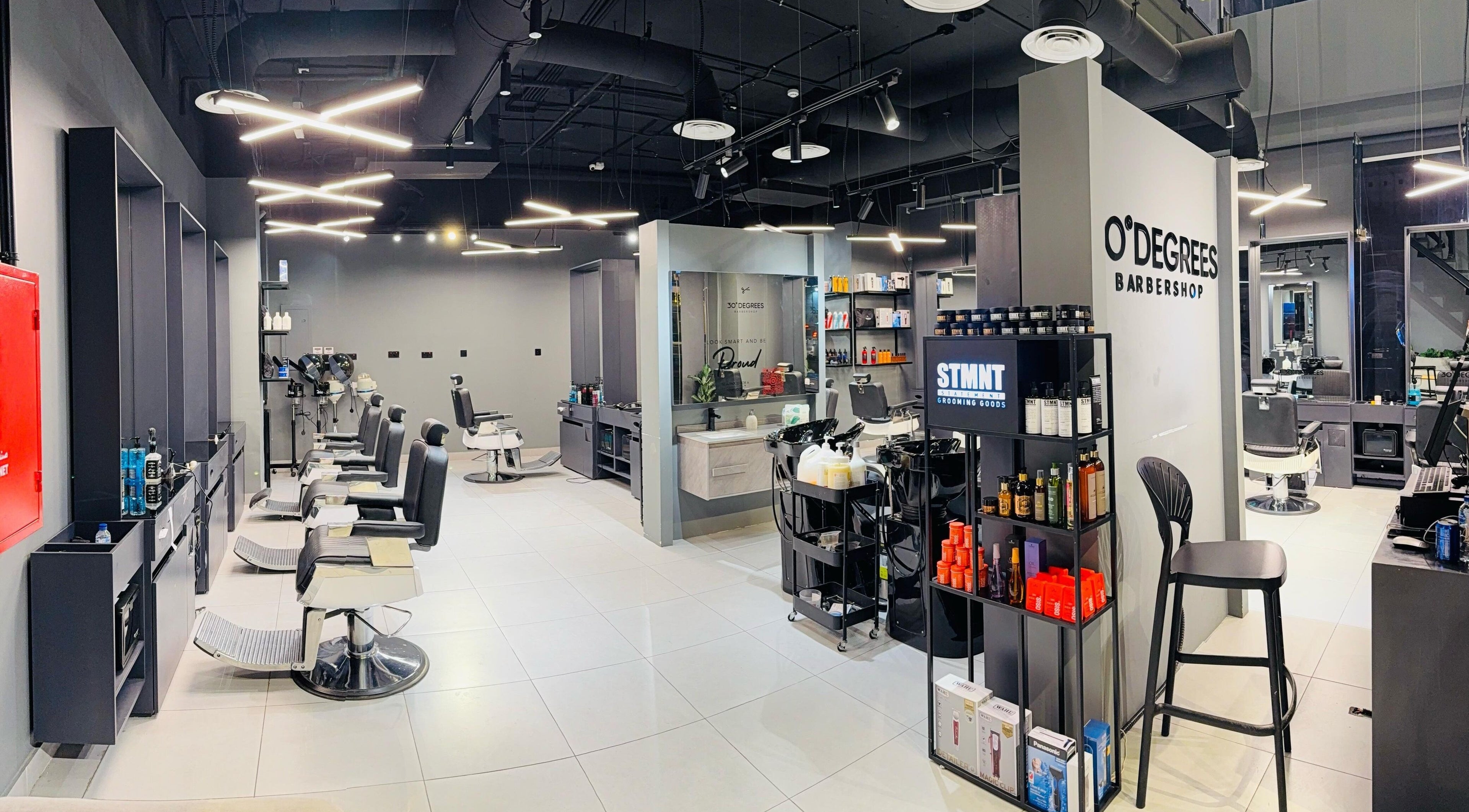 Interior of Jeddah 30 Degrees Alnaeem barbershop in Jeddah, Makkah Province, SA. Sleek chairs and stylish decor.